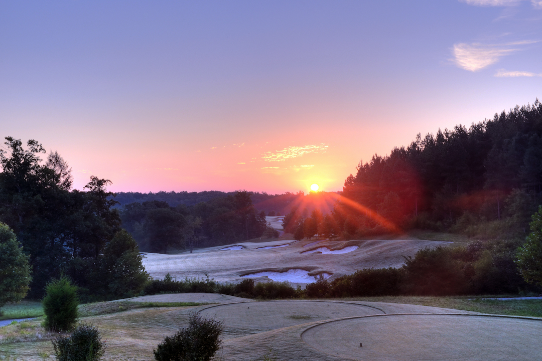 Professional Resort Photography and Video - Sunrise peeks through just prior to warming the frost in the grass